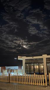 a building with a cloudy sky at night at Olive tree chalet and farm -مزرعه و شاليه شجره الزيتون 