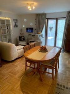 a living room with a table and a couch at Les Quatre Saisons in Vresse-sur-Semois