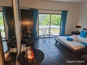 a hotel room with a bed and a balcony at The Venue Residence - SHA Extra Plus in Pattaya South