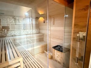 a shower with a glass door in a bathroom at Oasis in the heart of the Harz - Sauna in Thale +25 photos