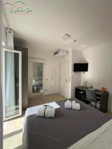 a bedroom with a large bed with a desk and a sink at La valle del ciglioto in Licusati