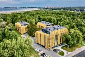 an overhead view of two yellow buildings next to a beach at Premium Seaside Escape with Forest View and Free Parking in Tallinn