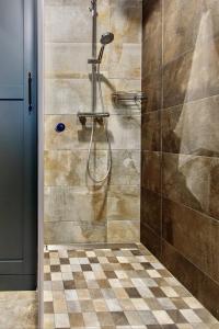 a bathroom with a shower with a checkerboard floor at Premium Seaside Escape with Forest View and Free Parking in Tallinn +14 photos