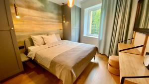a bedroom with a bed and a window at Premium Seaside Escape with Forest View and Free Parking in Tallinn