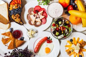 a table topped with plates of food and fruit at Grand Nur Hotel in Tashkent +44 photos