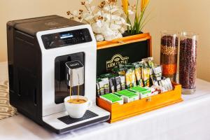 a coffee maker sitting on top of a table at Grand Nur Hotel in Tashkent