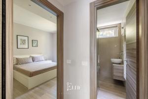 a bedroom with a bed and a sink and a mirror at Lake Maggiore View Apt Ranco in Ranco