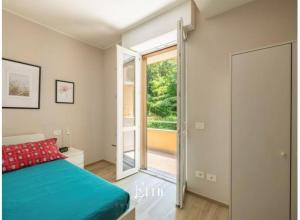a bedroom with a bed and a sliding glass door at Lake Maggiore View Apt Ranco in Ranco +3 photos