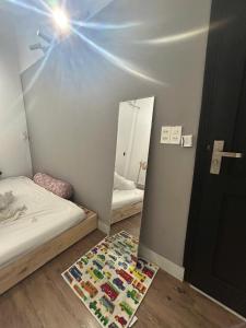 a bedroom with a mirror and a bed and a rug at Anhbnb in Da Nang +3 photos
