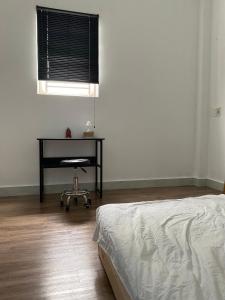 a bedroom with a desk and a bed and a chair at Anhbnb in Da Nang