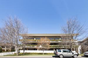 a white car parked in front of a building at Bright & Spacious Penthouse by Parliament House in Barton