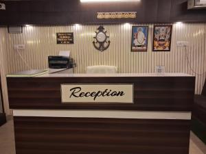 a reception desk in a store with a sign at The Royal Inn in Jāmb