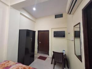 a room with a bed and a door and a chair at The Royal Inn in Jāmb +13 photos