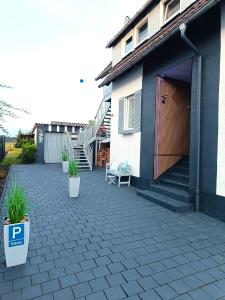 a patio in front of a house with a garage at Haus Gottschalk Nähe Küchenwelten in Niederdorla