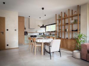 a kitchen and dining room with a table and chairs at Kwiat Sosny in Pszczew