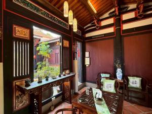 a restaurant with a table and chairs and a window at 校長的家The Principal Home in Jincheng