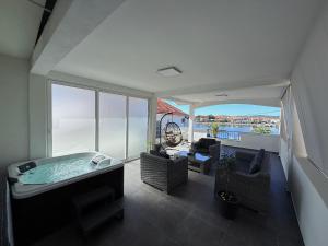 a large room with a hot tub and a balcony at Apartment Leona & Doris in Bibinje