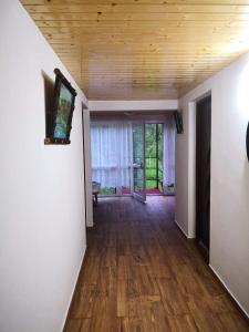 an empty room with a wooden ceiling and wooden floors at Casa Eliana in Călimăneşti