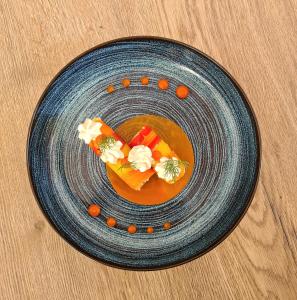 a blue plate with food on a table at Best Western Plus Hotel & SPA Le Schoenenbourg in Riquewihr