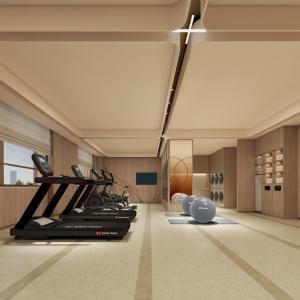 a gym with a treadmill and a cross on the ceiling at Hilton Garden Inn Songyuan Ningjiang in Songyuan
