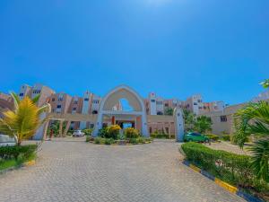 a building in the middle of a street with palm trees at bespoke stays in Mombasa