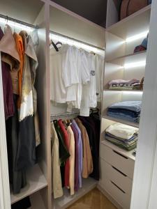 a walk in closet filled with lots of clothes at Capital Park in Astana