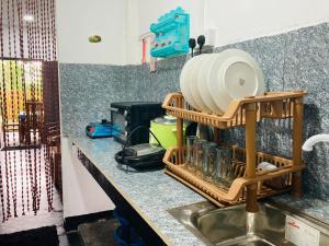 a kitchen counter with a drying rack next to a sink at D Mount Villa in Ahangama