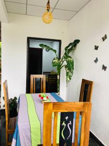 a dining room with a table and a plant at D Mount Villa in Ahangama