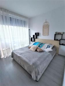 a bedroom with a large bed and a large window at Decor in Atlantis Resort&SPA by RV Apartments in Burgas City