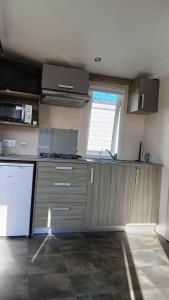 an empty kitchen with a counter and a window at Camping Costa da Morte in Zas +31 photos