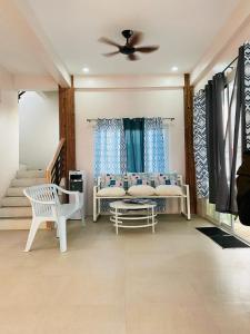 a living room with a couch and a ceiling fan at TEZA by the Z - Beachfront Vacation Villa Rental in Ocoy