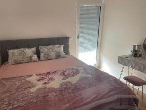 a bedroom with a large bed and a window at Schöne Wohnung in Korneuburg