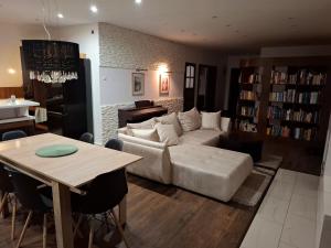 a living room with a white couch and a table at Apartamenty TUTERRA IV in Zabagnie
