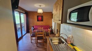 a kitchen with a table and a couch in a room at Orelle 3 Vallées - 2 pièces 5-6 personnes in Orelle