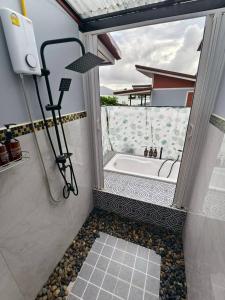 a bathroom with a shower with a tub and a window at Relax sunsmile Kohyaonoi in Ko Yao Noi +183 photos