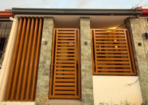 two wooden shutters on the side of a building at KENNA'S NOOK in Butuan