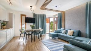 a living room with a couch and a table at STEGNA PARK B Apartamenty PIAMOLA in Stegna