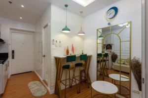 a kitchen with a bar with stools and a mirror at Unique Chiq and comfy place with board games, Quezon City in Manila +15 photos