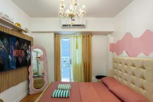 a bedroom with a large bed and a mirror at Unique Chiq and comfy place with board games, Quezon City in Manila