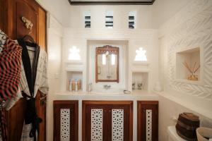 a bathroom with a sink and a mirror at Lamu Treasures Shela Kenya in Shela