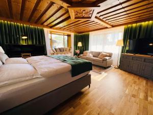 a bedroom with a large bed and a television at Urlaub am Schafhof in Rimbach