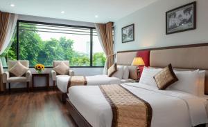 a hotel room with two beds and a window at Skylark Hotel & Spa Ha Noi in Hanoi +25 photos
