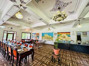 a dining room with tables and chairs and a chandelier at The Lal Bagh in Kumbhalgarh