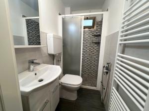 a white bathroom with a toilet and a sink at 67 Bellaria Bilocale vicino al mare in Bellaria-Igea Marina