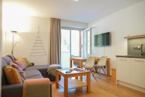 a living room with a couch and a table at Kovárna Residence in Pec pod Sněžkou