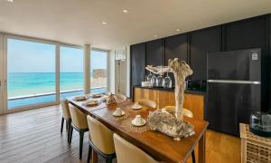 a dining room with a table and chairs and the ocean at 芯宿月汀里 in Jeju