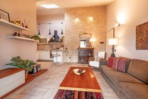 a living room with a couch and a table at Domus Ghirada Terrace in Treviso