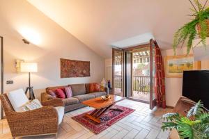 a living room with a couch and a tv at Domus Ghirada Terrace in Treviso