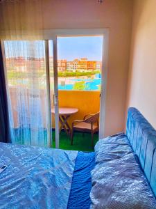 a bedroom with a bed and a view of a patio at Porto Sharm Family Chalet with Pool View in Sharm El Sheikh +83 photos