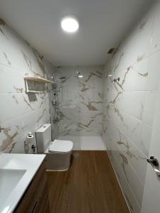 a bathroom with a toilet and a sink at Apartamentos JM - Sea & Sun in Roquetas de Mar